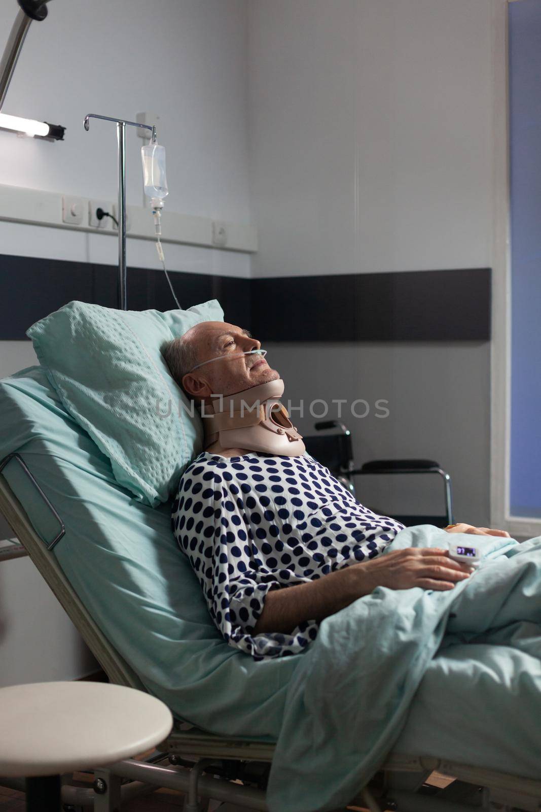 Senior man suffering after serious accident laying in hospital bed by DCStudio