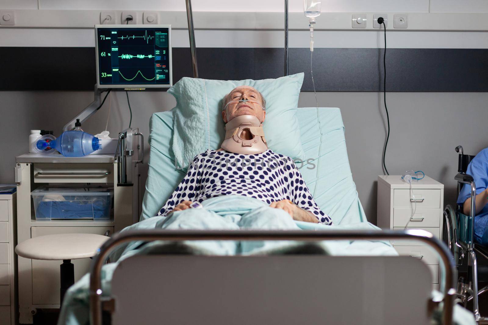 Hospitalized senior laying unconscious in hospital room bed by DCStudio
