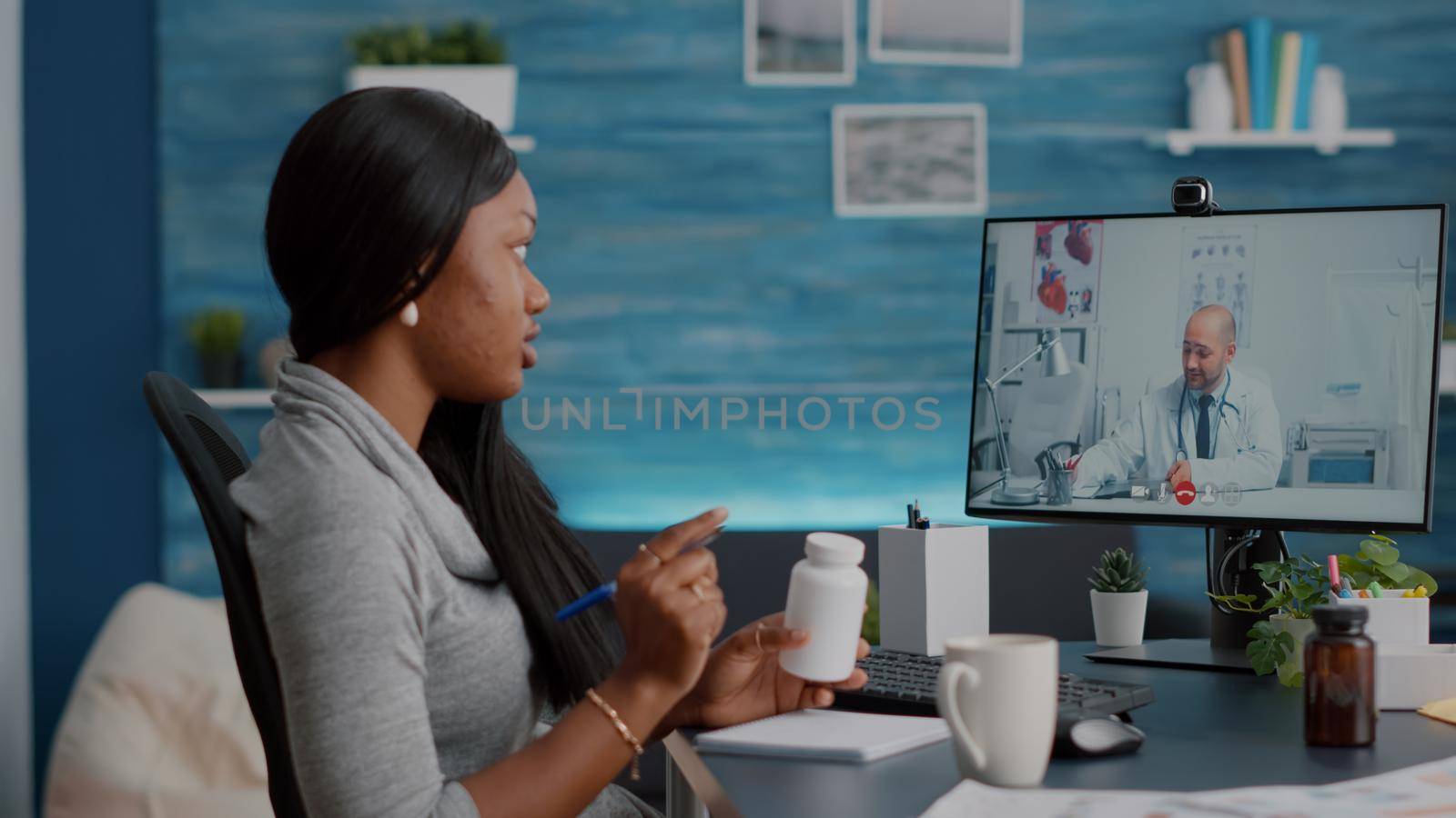 African student talking with physician doctor explaining sickness symptom discussing pills treatment during online telemedicine videocall conference meeting. Teenager having respiratory illness