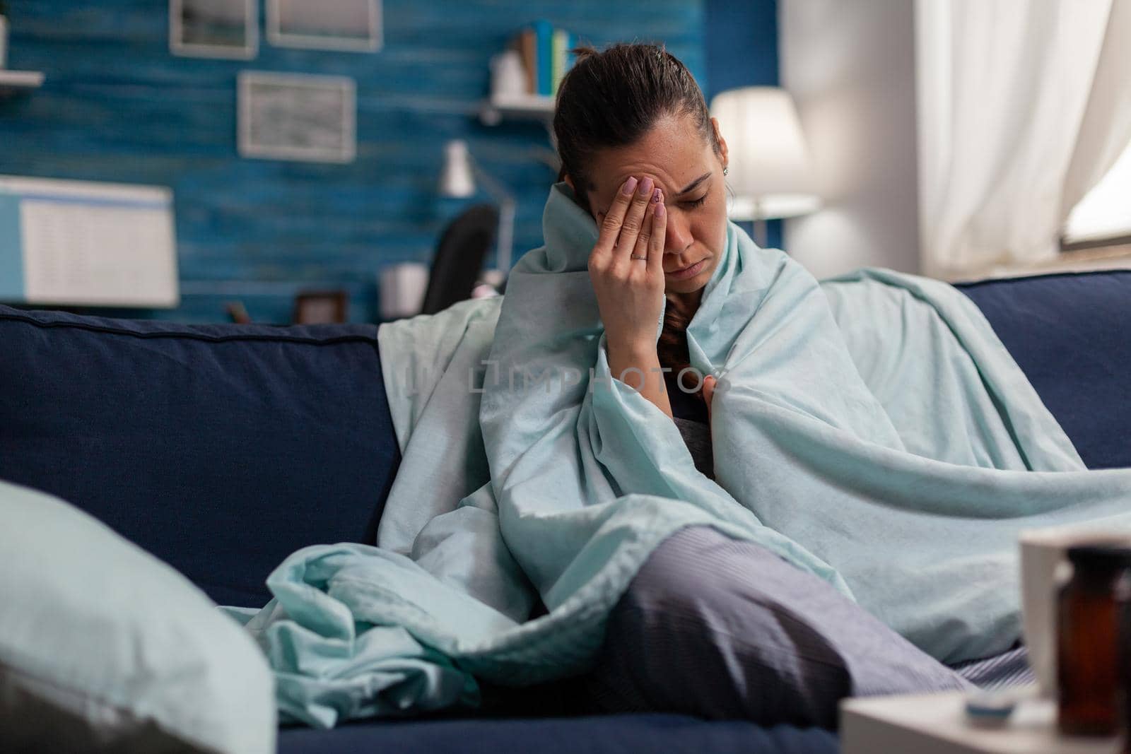 Young woman with migraine being sick at home by DCStudio