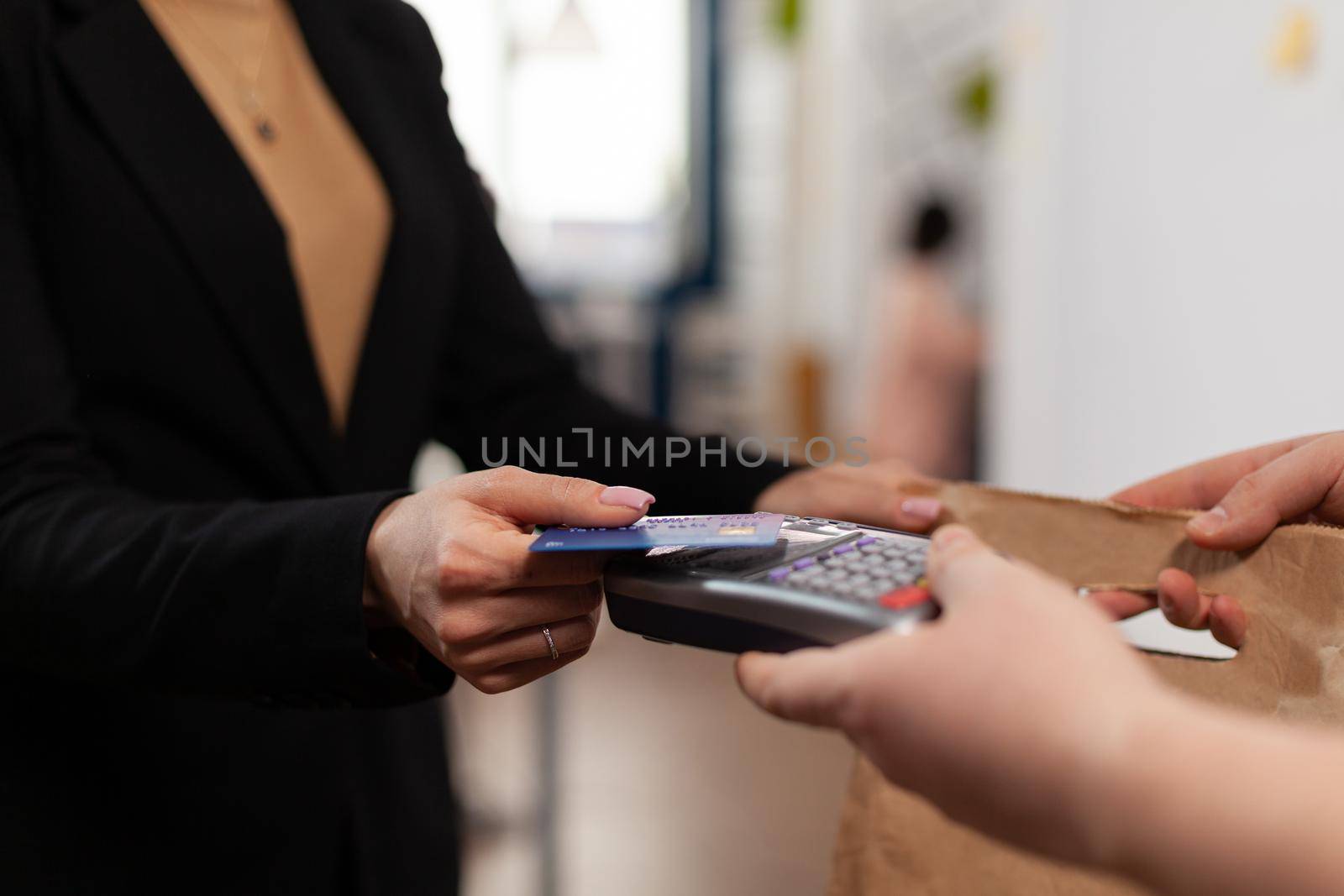 Close up of businesswoman holding plastic credit card in hand by DCStudio