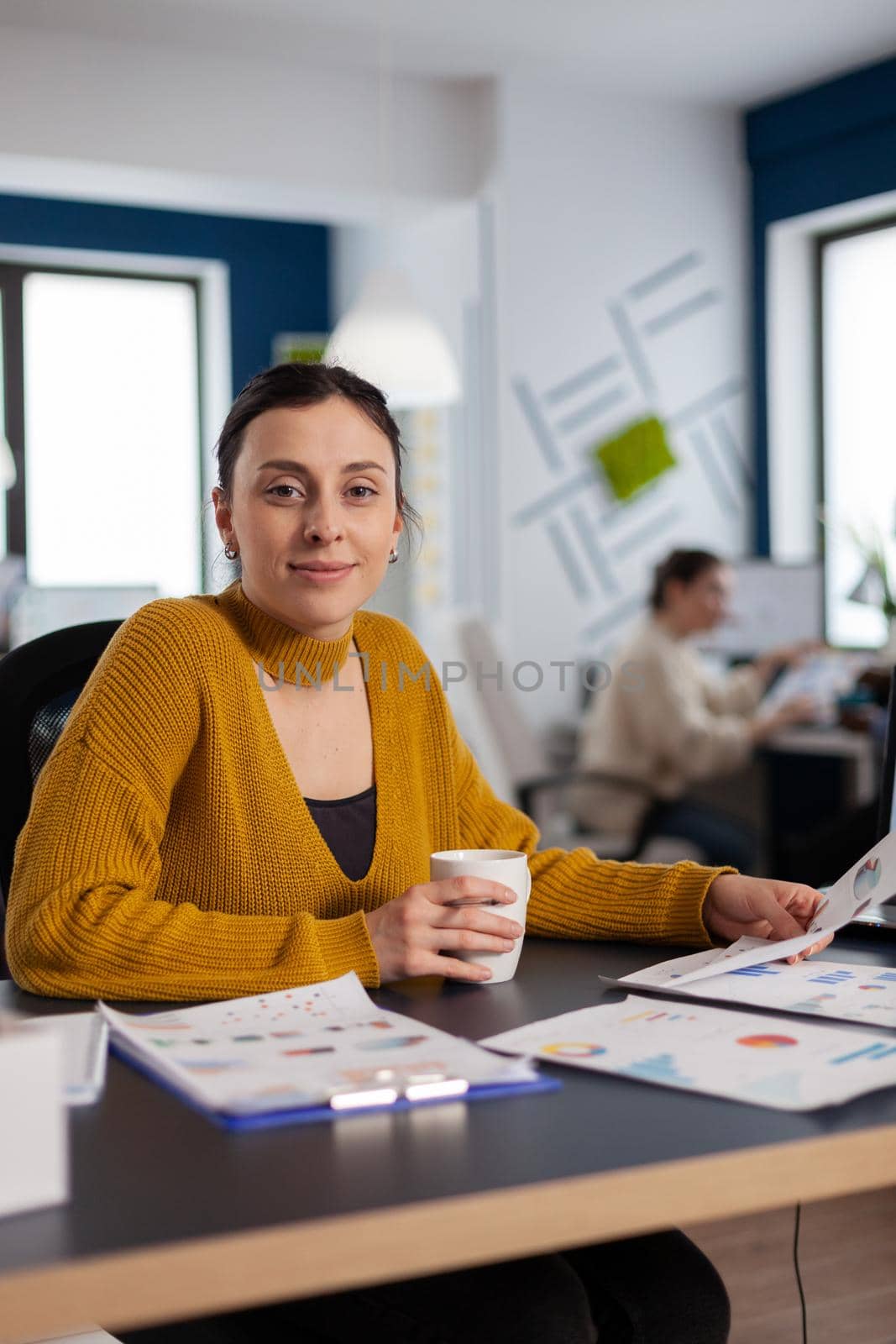 Company leadership orf financial company looking at camera holding documents with charts Executive entrepreneur, manager leader sitting working on projects with diverse colleagues.