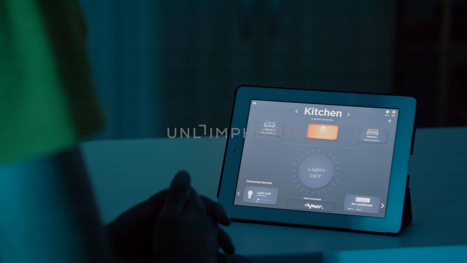Man talking to voice assistant on tablet in smart home automation system by DCStudio