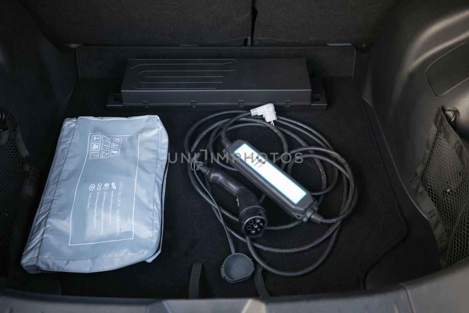 Close up of the power supply for electric car charging. Charger Access to vehicle electrification. The boot of the electric car with the charger by uflypro