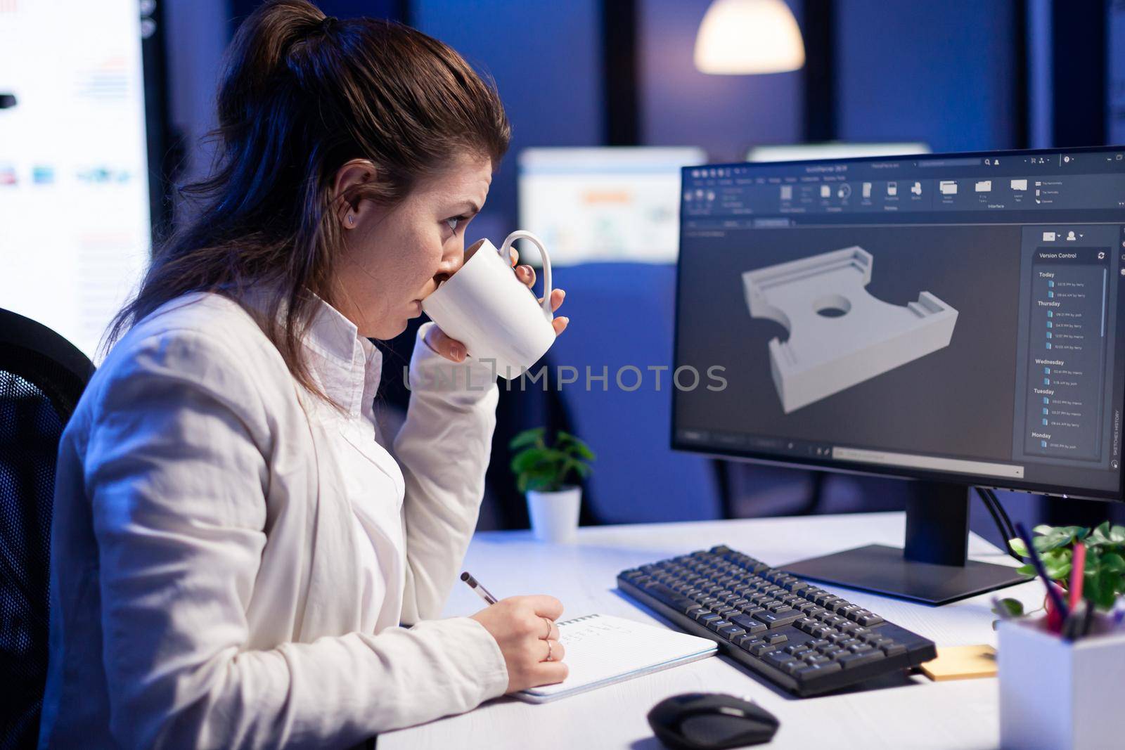 Software engineer working at digital cad project late at night in office company. Woman entrepreneur looking at technical construction before deadline using modern technology network