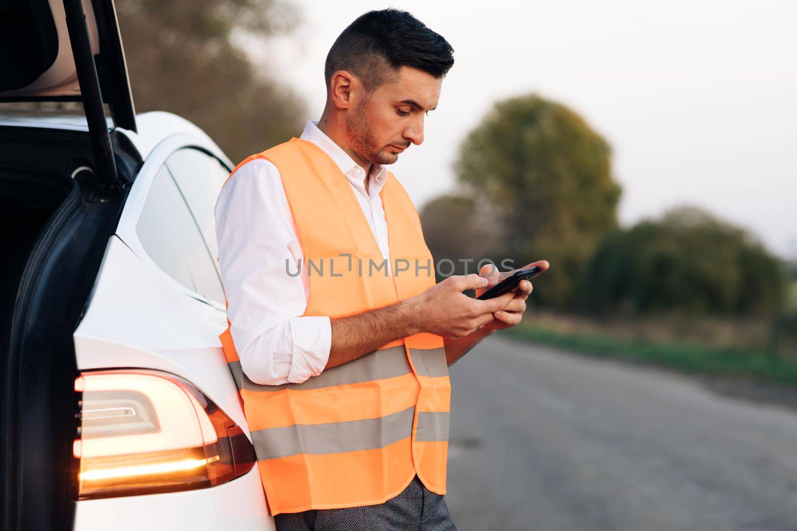Sad Disappointed Man On Broken Electric Car. Vehicle Check Damage Troubles. Discharged electric car. Auto Failure Accident Inspection by uflypro