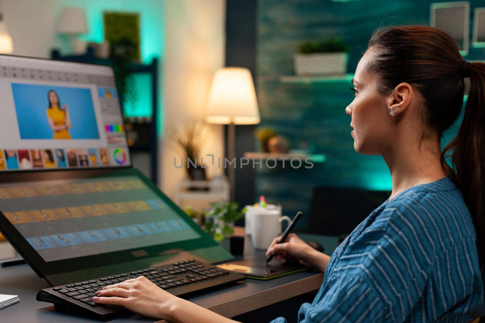 Photo editing expert retouching background on photo image for lights and gradient using digital tablet and stylus. Graphic design specialist woman working on template virtual project