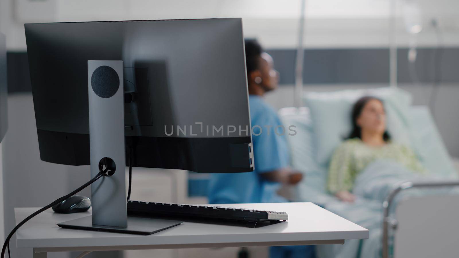 Afro-american woman examining bones radiography checking sickness recovery. Sick woman patient sitting in bed discussing disease treatment in hospital ward during therapy consultation