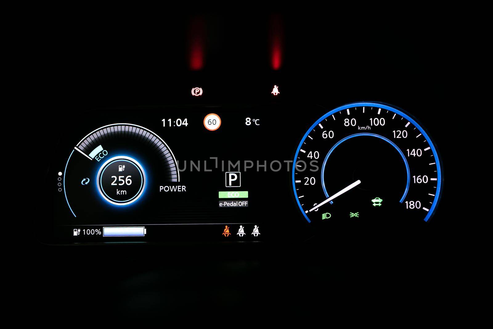 Starting electric car Dashboard. Track in to the button. Finger press the button to start the car engine. Car dashboard during start engine on the darkness. Electric car dashboard with backlight. by uflypro
