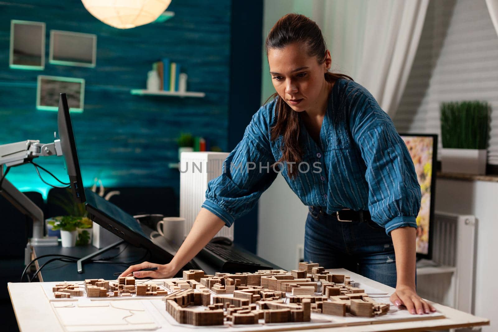 Professional architect standing at maquette table by DCStudio