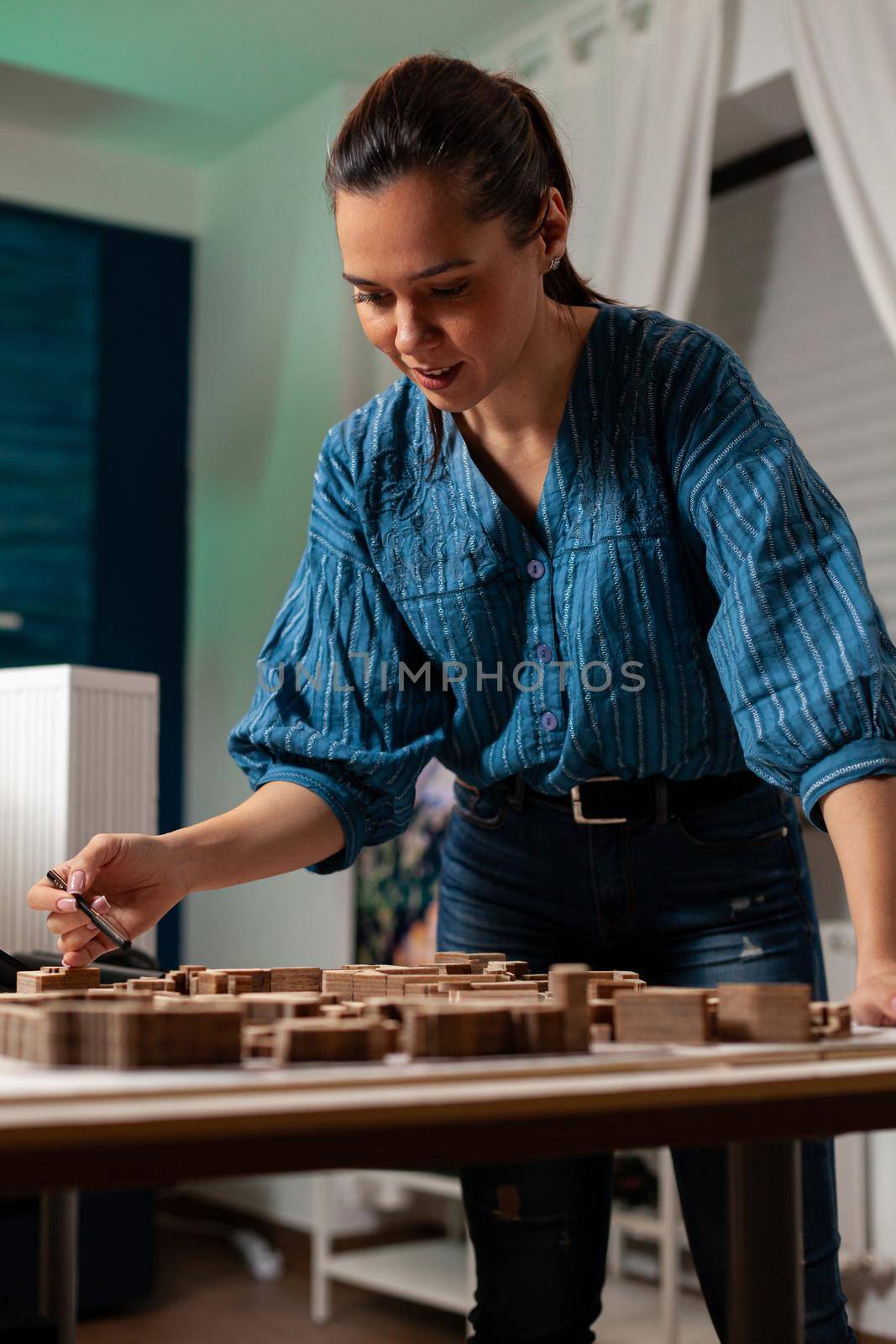 Caucasian worker standing at business desk office doing architectural design project for futuristic development construction. Professional woman working on maquette for renovation concept