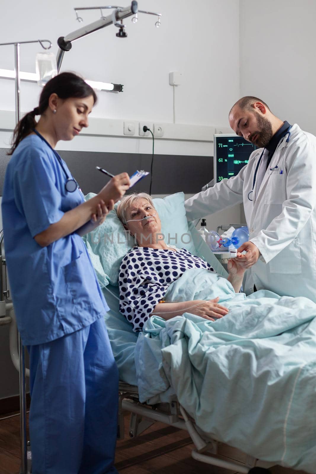 Doctor checking senior patient in hospital intensive care by DCStudio