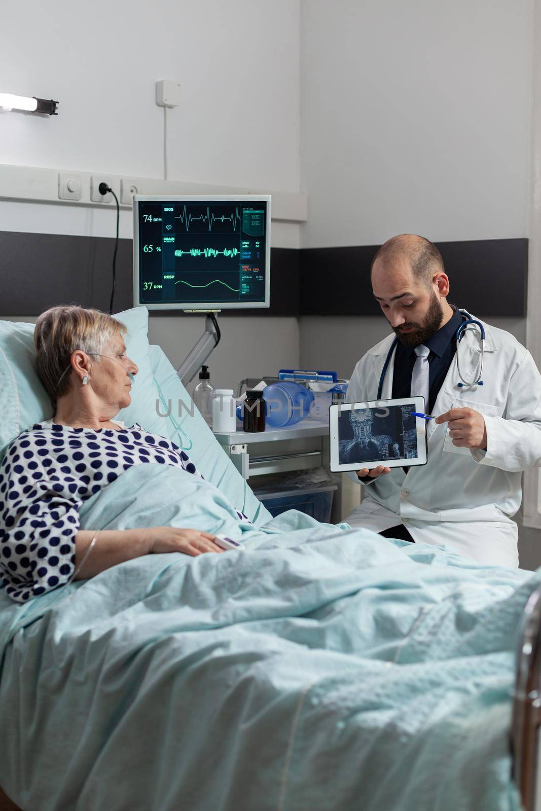 Sick senior woman receiving a medication through an intravenous line by DCStudio