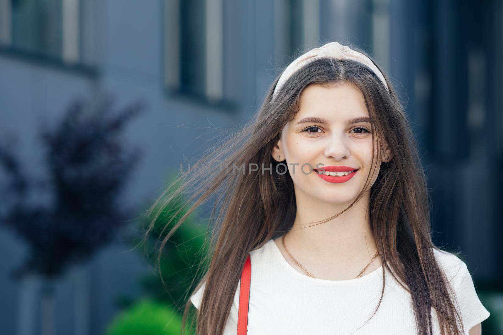 Stylish pretty woman outdoor. Young smiling woman having fun in city. Red lipstick. Portrait of sexy smiling caucasian young woman model with glamour red lips,bright makeup