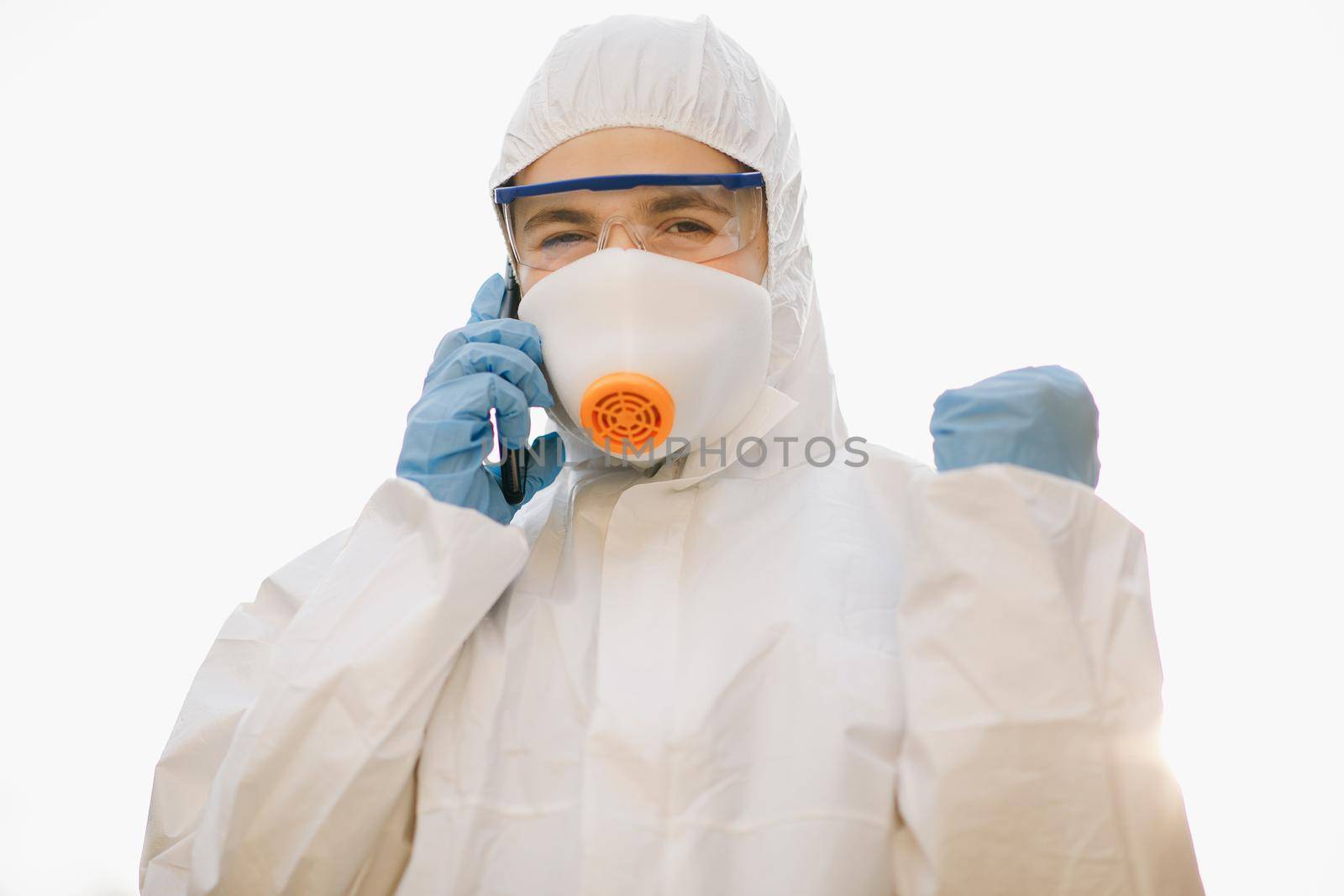 Medical worker portrait, Confident Asian doctor in protective PPE suit wearing face mask and eyeglasses. Worker in chemical protective suit on a white background by uflypro