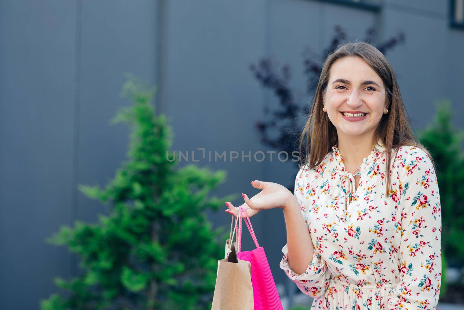 Young woman shopping. Shopping young woman smiling in the shopping mall. Woman with shopping bags. by uflypro