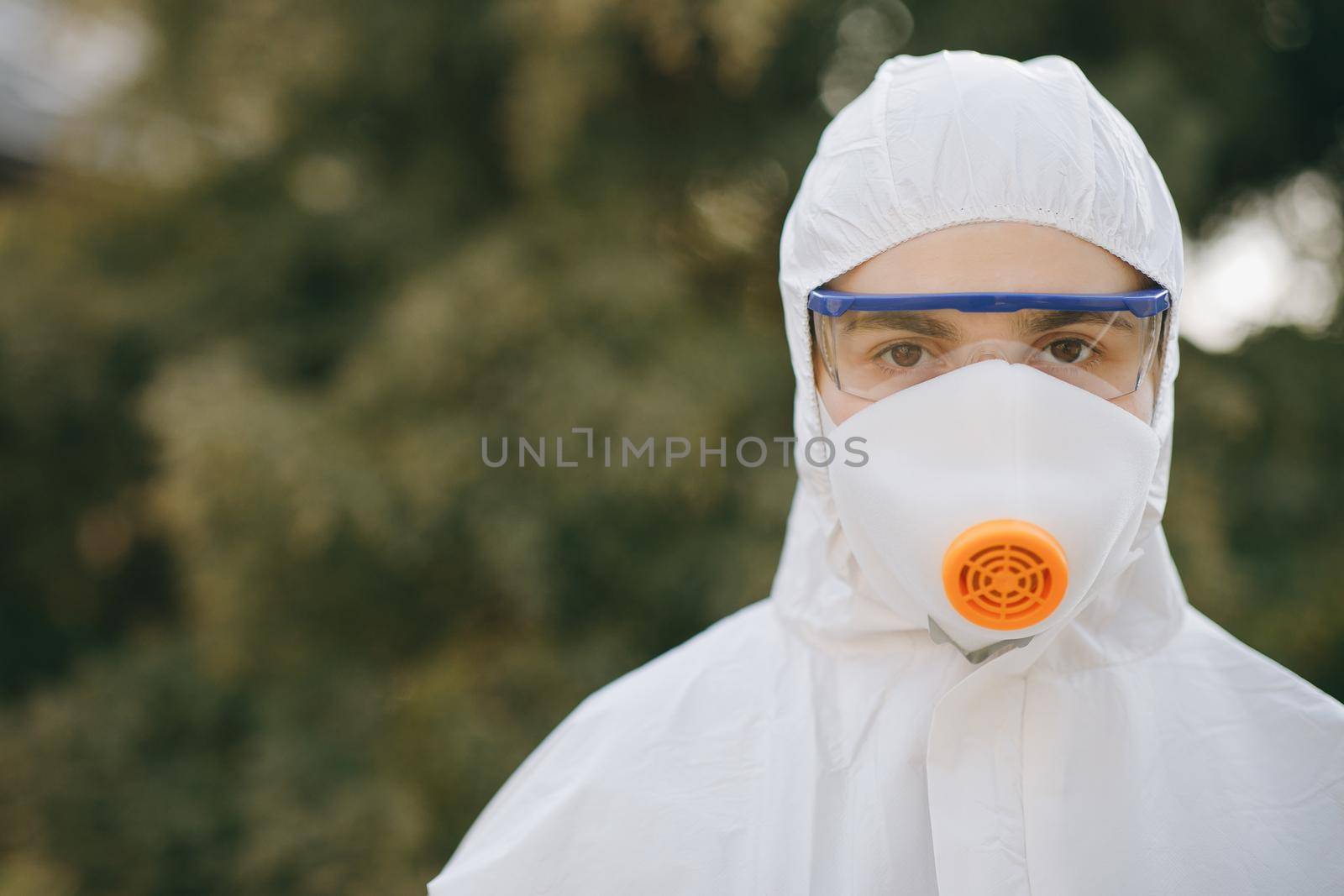 Portrait of doctor epidemiologist fighting with coronavirus COVID-19. Protection mers by virologist. White medical suit with mask, gloves, glasses. Face of global crisis during epidemic. by uflypro