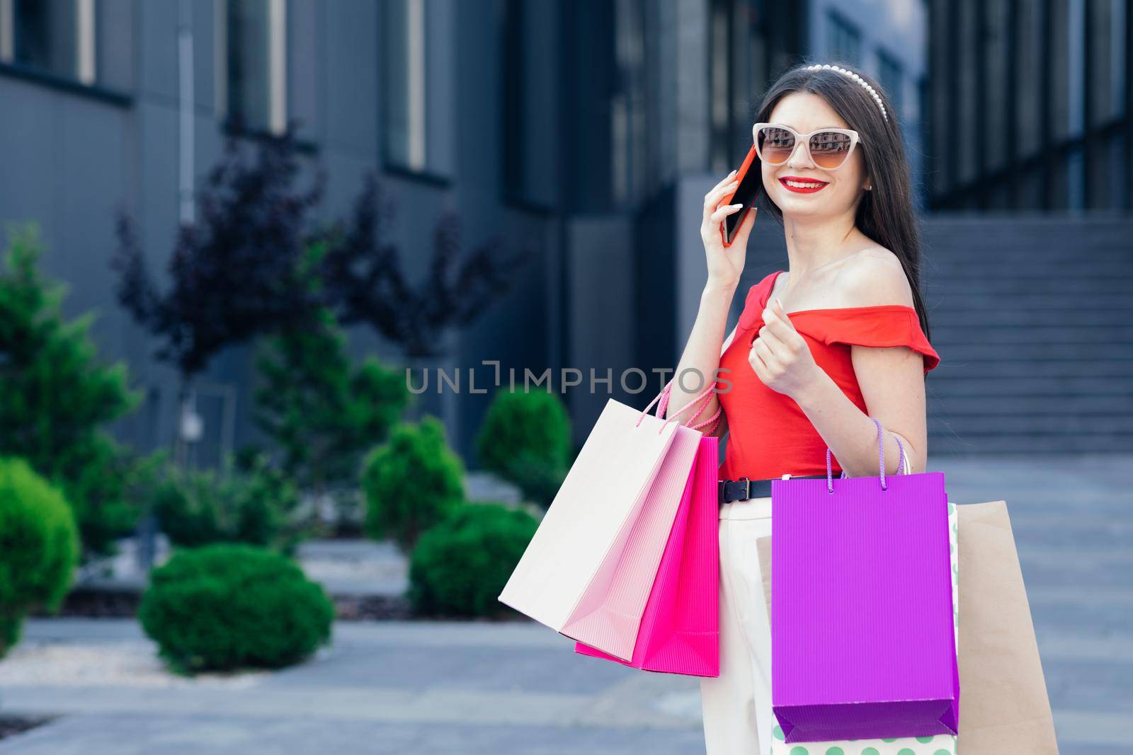 Shopping and tourism concept. Beautiful girl with shopping bags. Shopaholic. sale and discount. girl online shopping. by uflypro