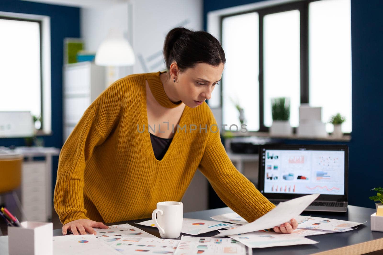 Corporate business woman reading statistics on documents paperwork Executive entrepreneur, manager leader standing working on deadline documents projects.