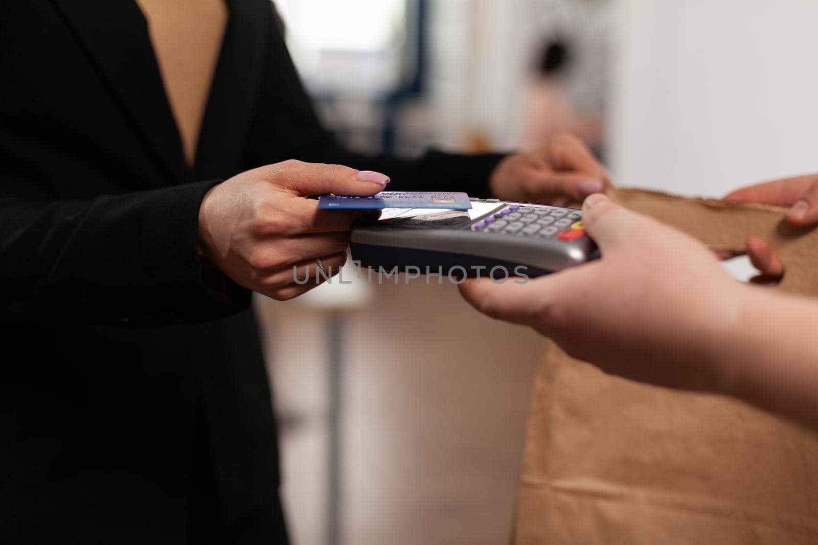 Close up of business woman holding credit card of pos by DCStudio
