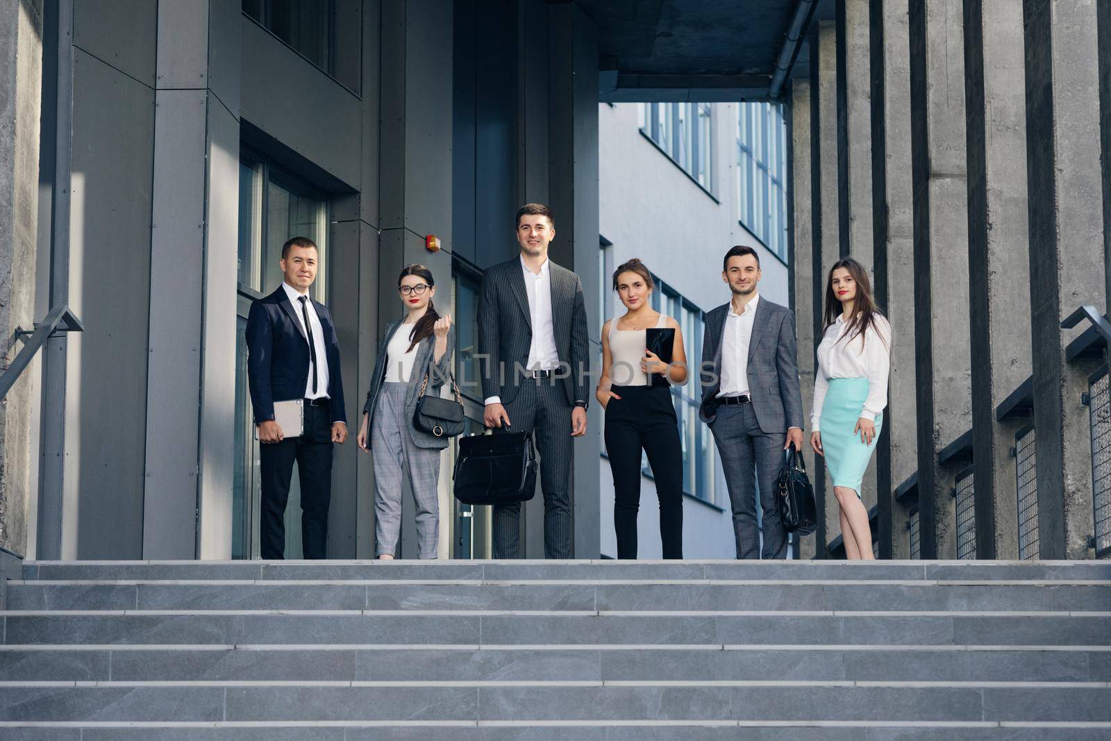 Happy proud professional diverse business people group look at camera. Corporate team portrait. Smiling team of diverse different generations business people looking at camera.