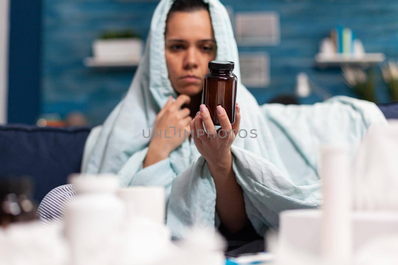 Young adult holding jar container of medicine for disease by DCStudio