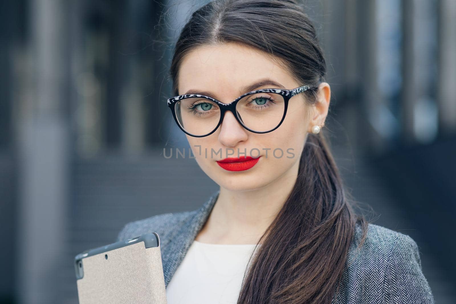 Close-up portrait of a gorgeous young woman wearing glasses. Beauty, fashion. Make-up. Optics, eyewear. Young businesswoman wearing glasses. by uflypro