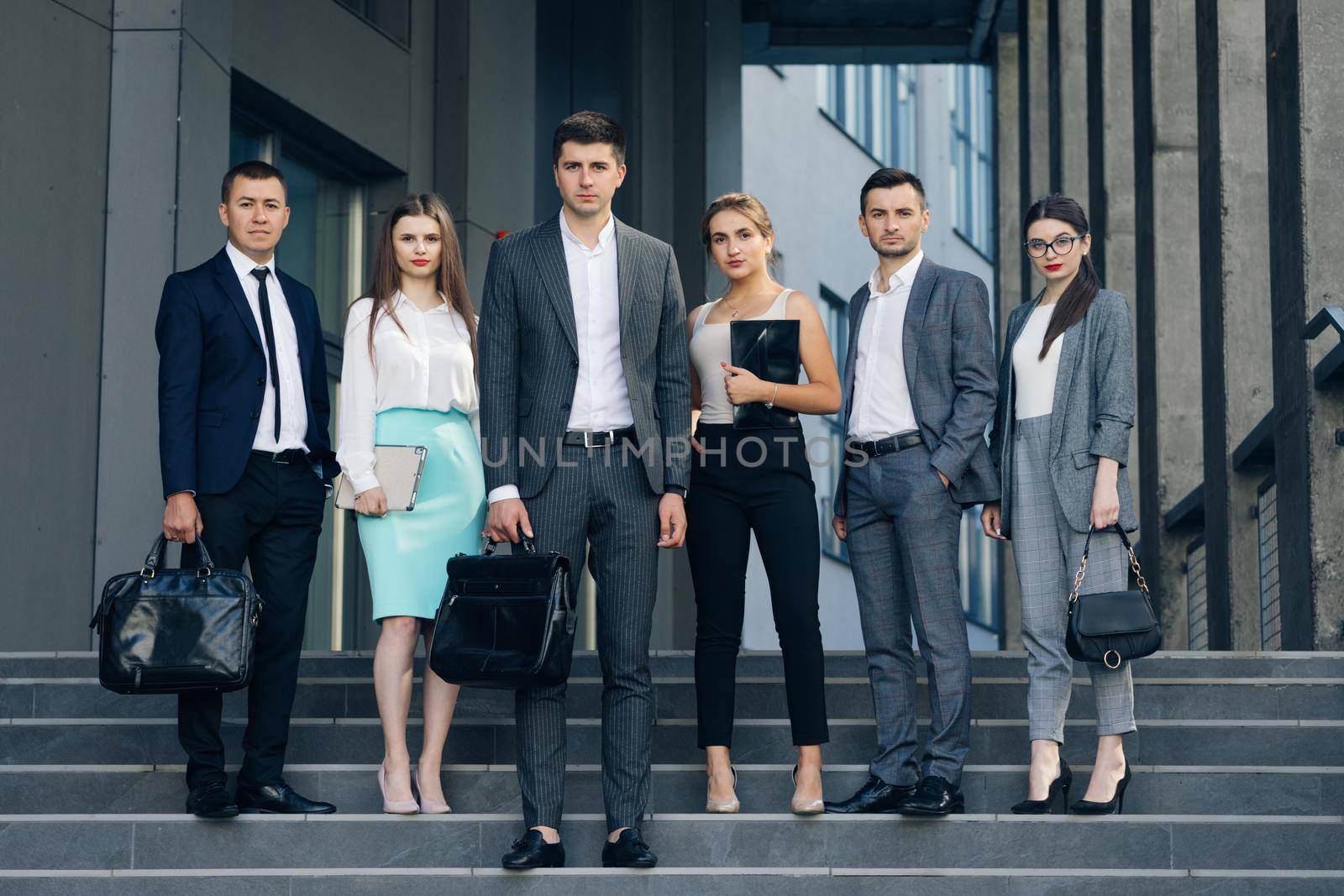 Professional corporate office business team members group look at camera. Six happy proud confident leaders employees staff people group stand together by uflypro