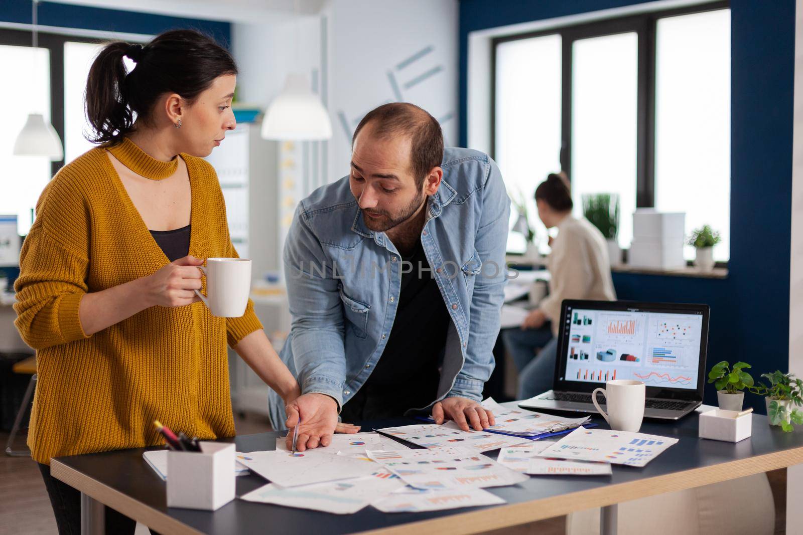 Company leadership during briefing talking looking at marketing statistics by DCStudio