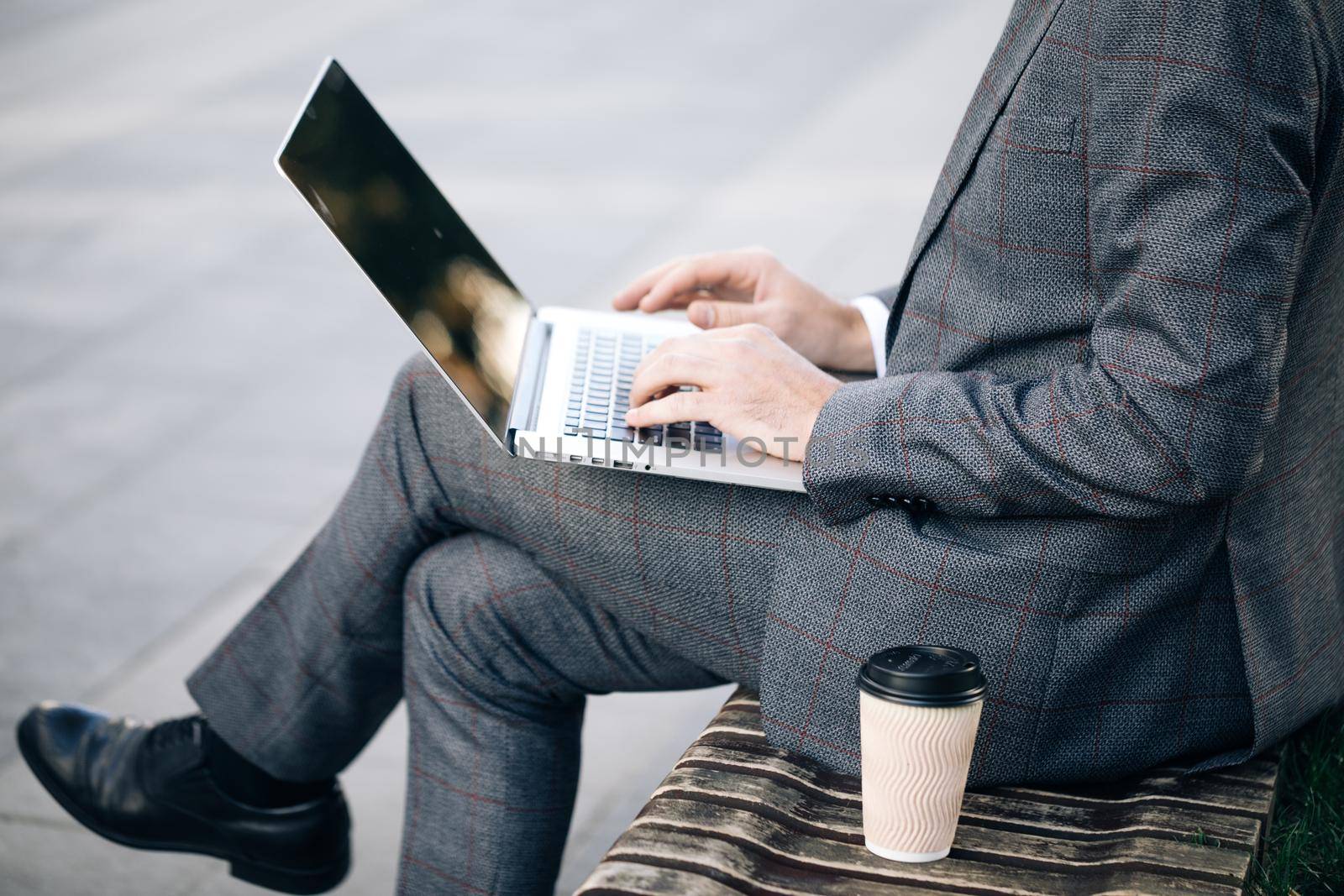 Freelancer's hands typing on laptop keyboard. Businessman working with internet. Man searches new job on internet. Business concept. Unemployment. Lack of jobs. Financial crisis by uflypro