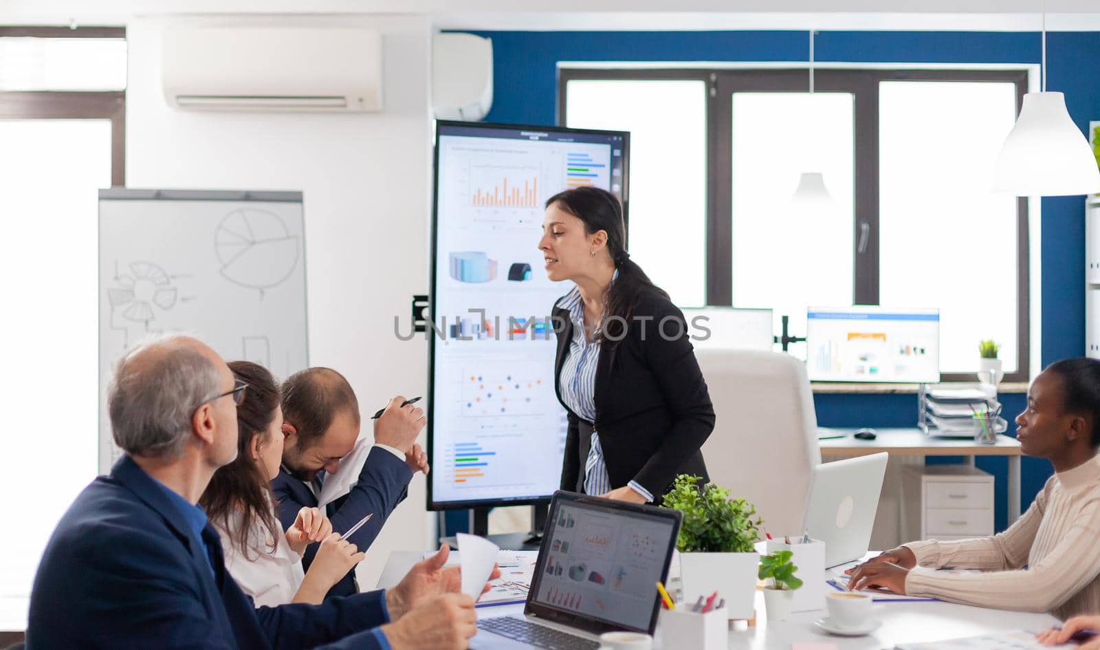 Furious entrepreneur hitting employee with clipboard by DCStudio