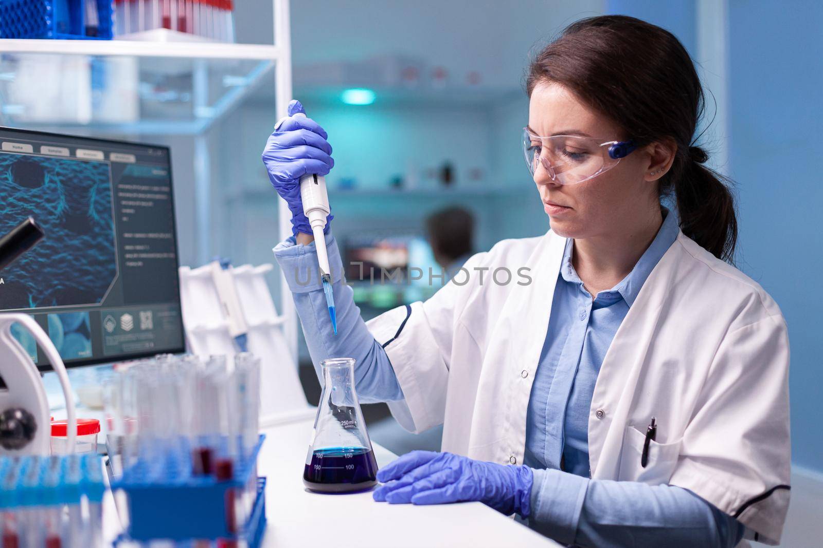 Professional scientist taking a sample for medical experiment by DCStudio