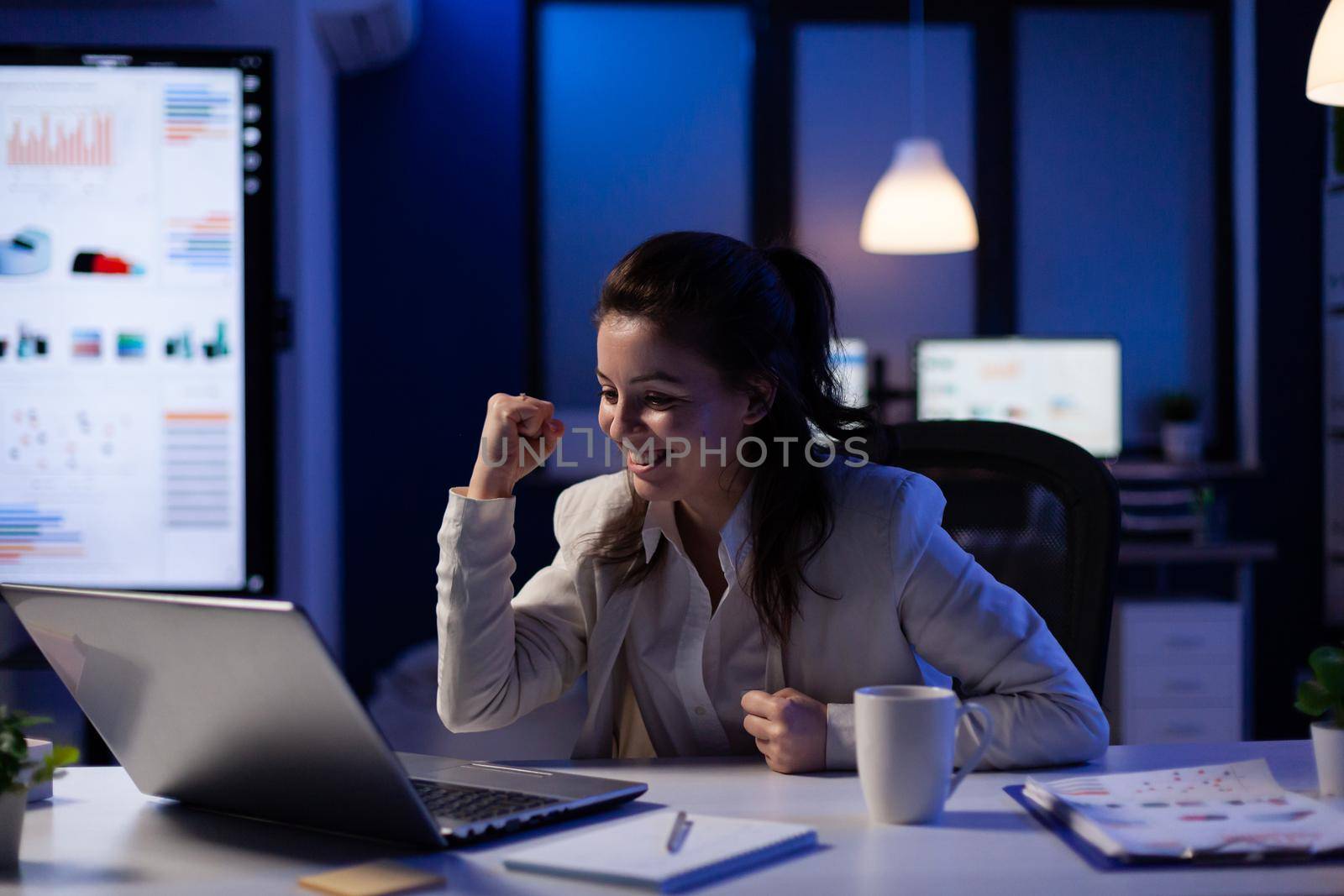 Excited woman checking laptop for celebrate online win success by DCStudio