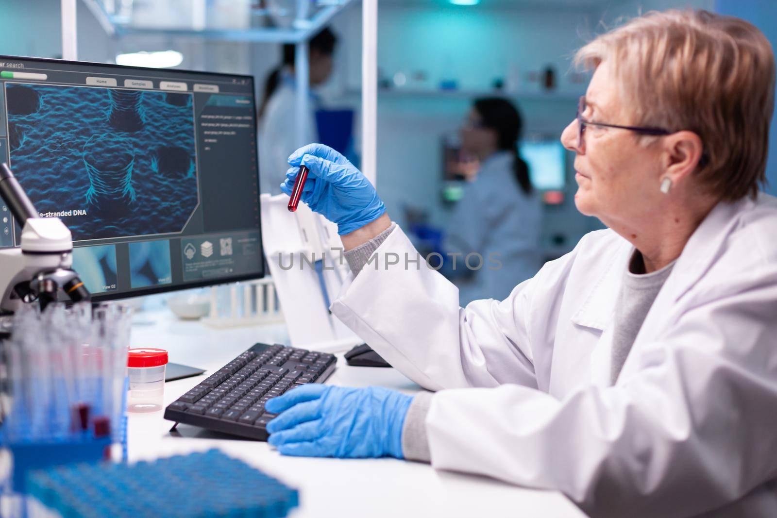 Scientist chemist taking a DNA sample for medical discovery by DCStudio