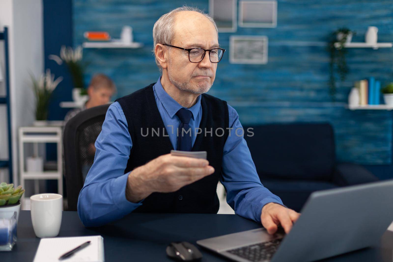 Senior man using credit card by DCStudio
