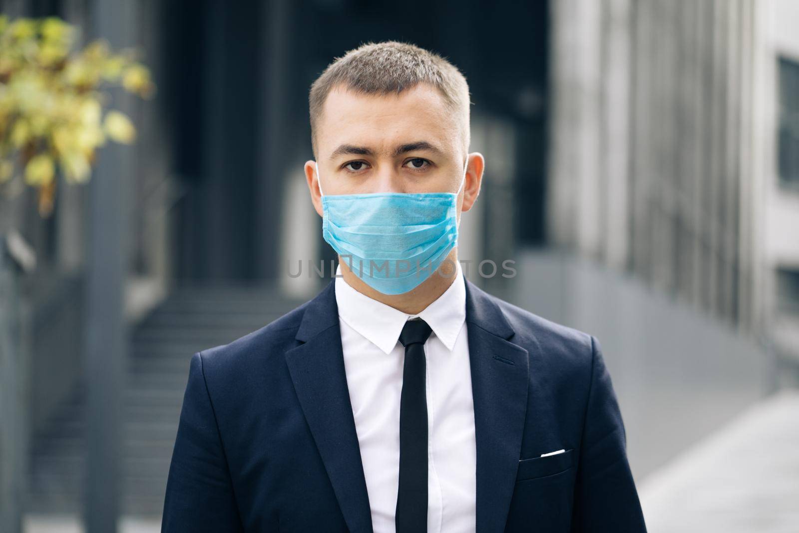 Portrait Business Man in Protective Face Mask Look at Camera COVID-19 Coronavirus Infection. Face mask Covid-19. Epidemic Coronavirus Mers. Pandemic Flu Corona Virus. Human Masked 2019-ncov.