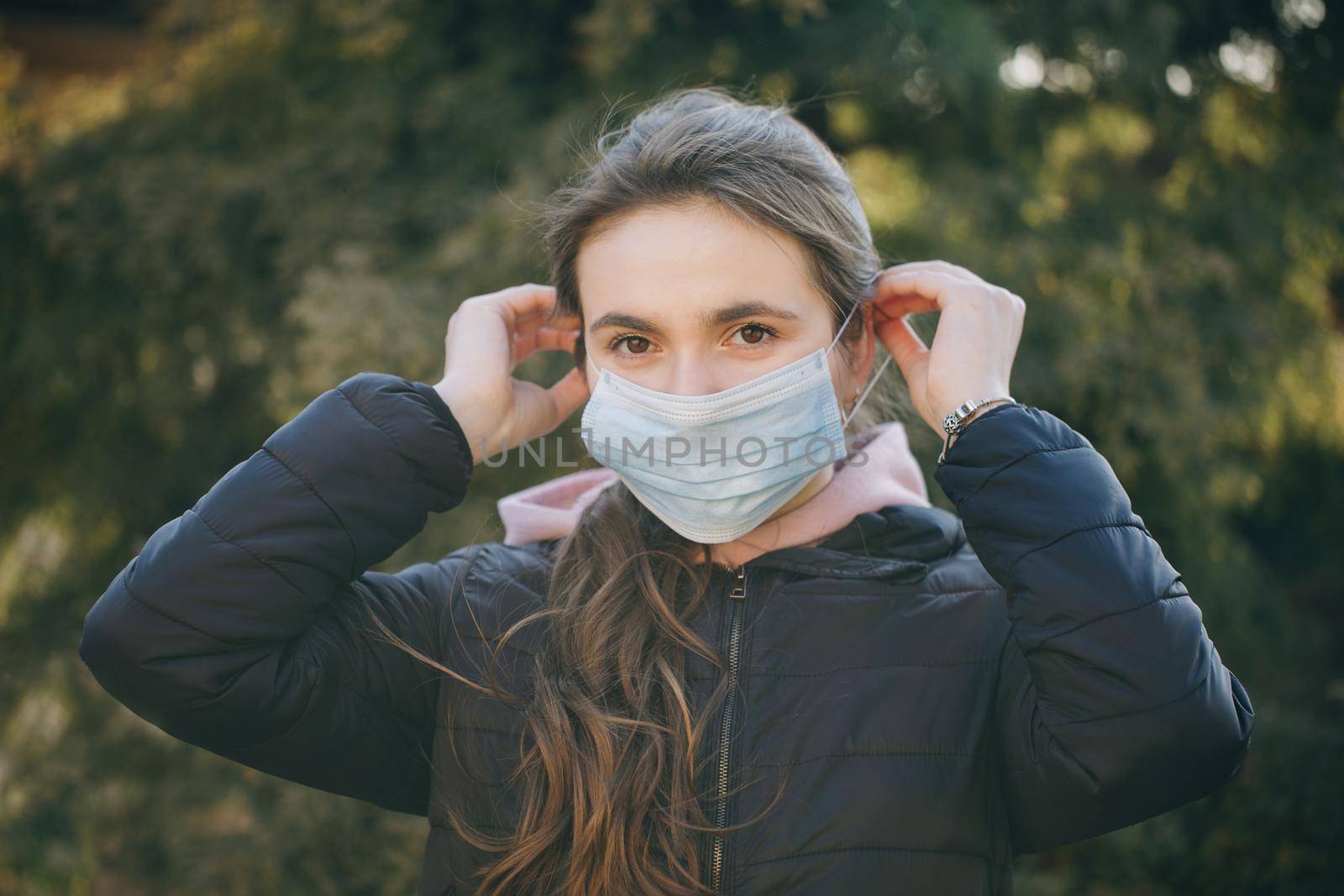 Girl Wearing Medical Mask During Coronavirus COVID-19 Epidemic. Concept of health and safety life, N1H1 coronavirus, virus protection by uflypro