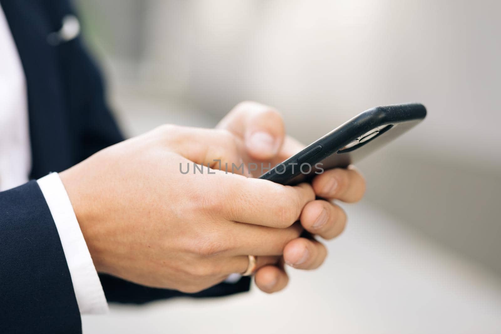 Close up of a man using mobile smart phone. Businessman working on the smartphone.