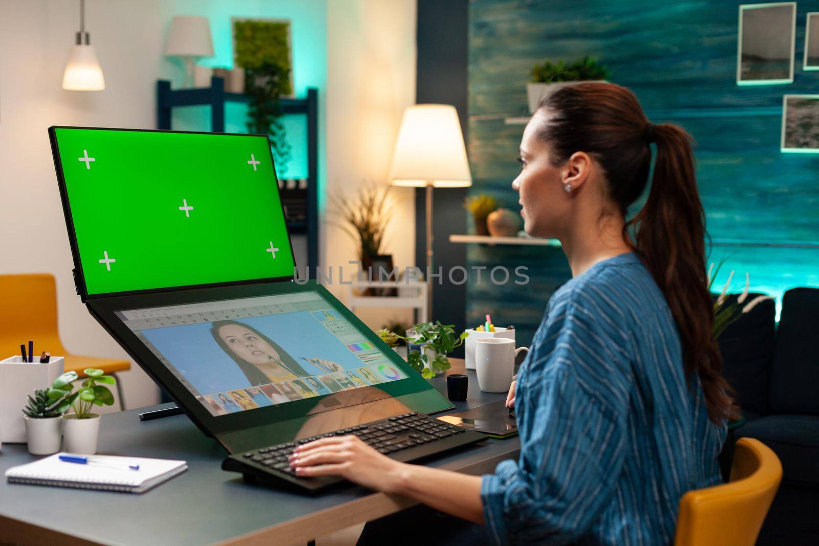 Office studio employee working with green screen by DCStudio