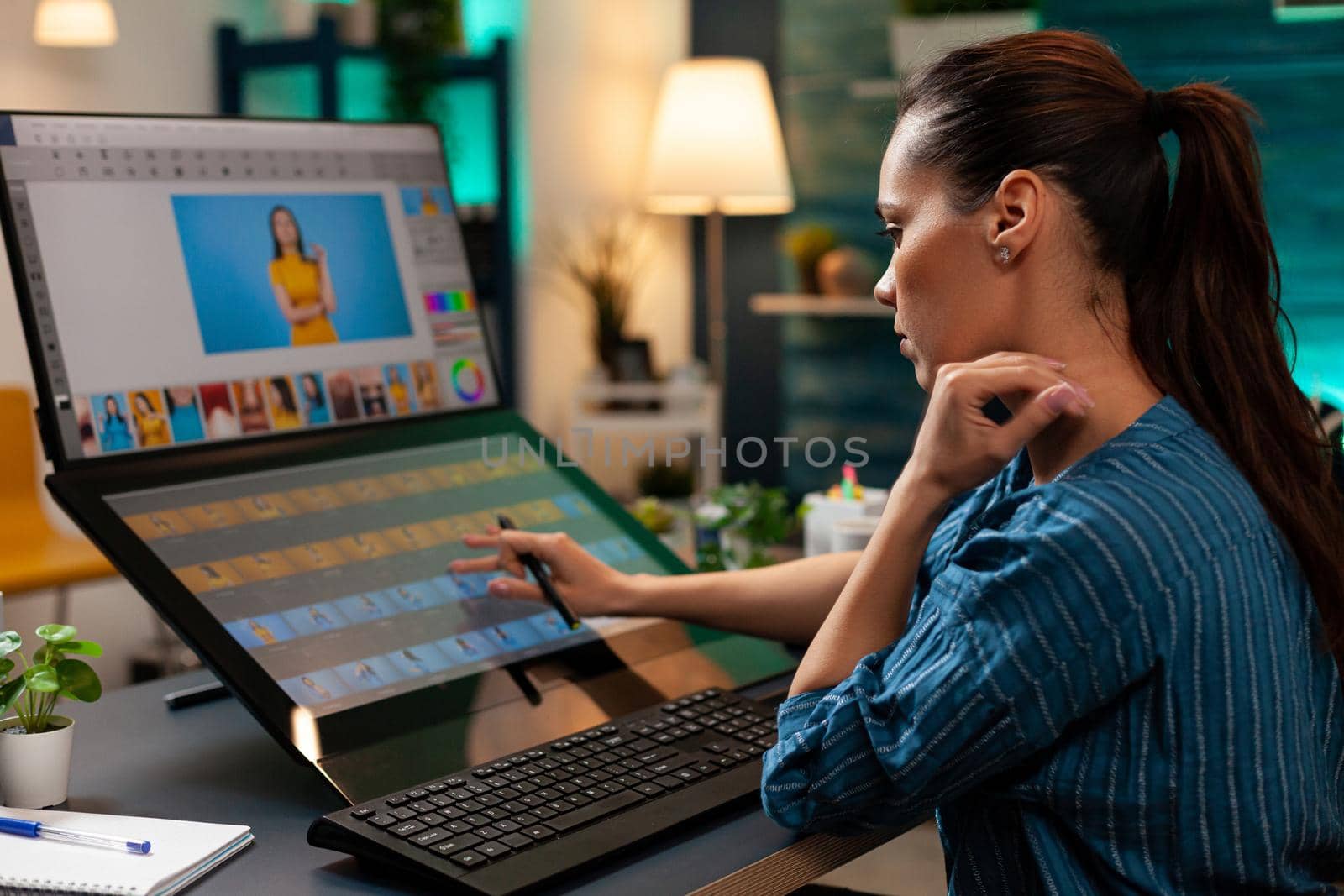 Studio editor doing retoucher work on touch screen computer monitor for occupation. Artist sitting at professional desk working with modern technology photography software and stylus