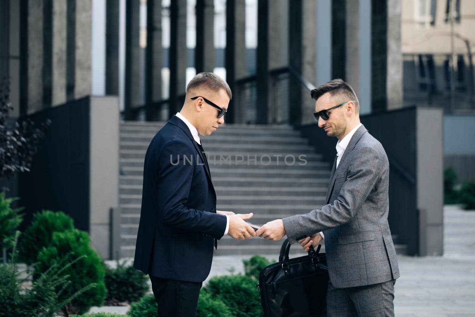 Two unrecognized business partners shaking hands. Colleagues just made good deal. Business relationship. Successfully made deal. Handshake - business people shaking hands by uflypro
