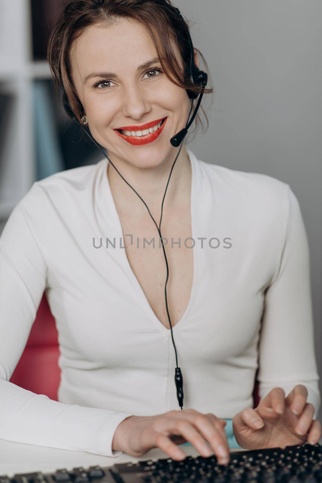 Happy woman in headphones speaking by webcam at webinar training look at laptop make notes, girl student talking by video conference call, online teacher teaching consulting client e-coaching concept. by uflypro