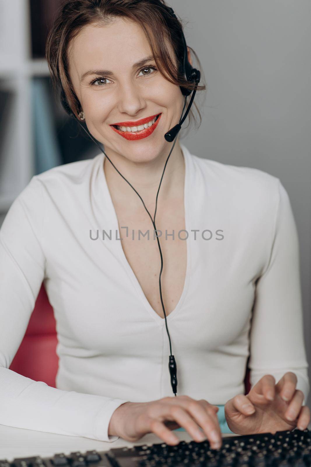 Happy woman in headphones speaking by webcam at webinar training look at laptop make notes, girl student talking by video conference call, online teacher teaching consulting client e-coaching concept