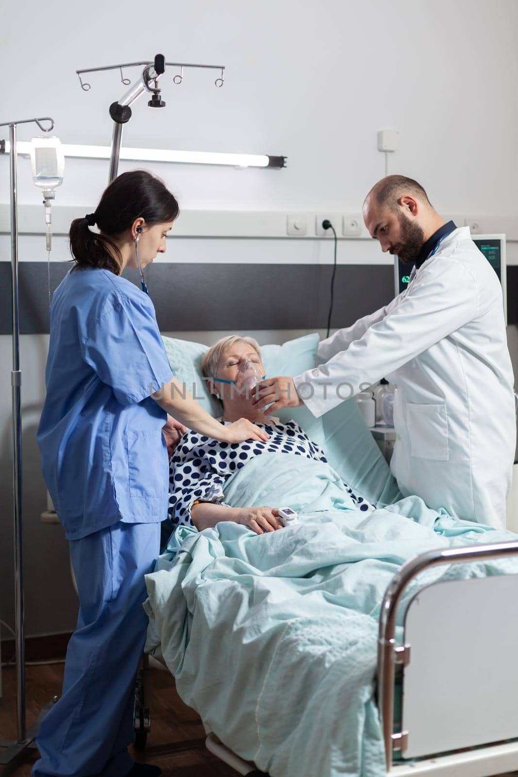 Unconscious senior woman patient laying in hospital bed by DCStudio