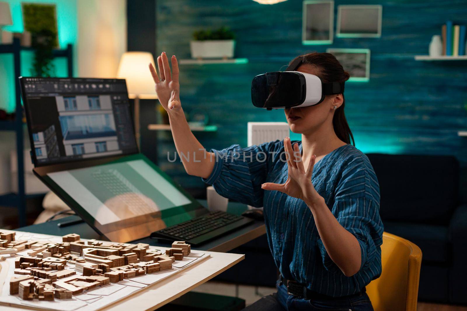 Modern business woman with vr glasses for innovation development vision using interactive software. Virtual designer working on holographic simulation experience for building model