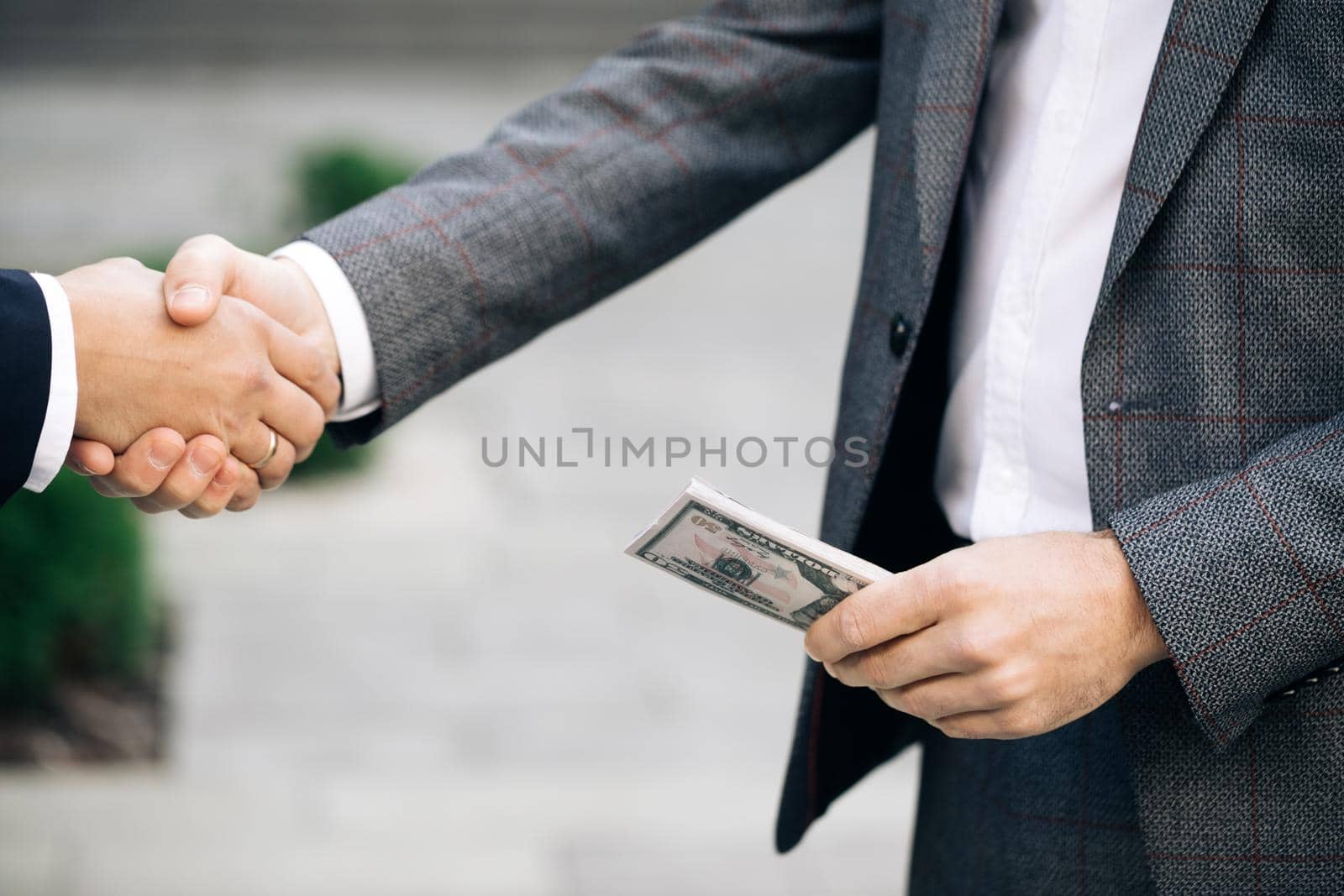 Handshake - business people shaking hands. Two unrecognized business partners shaking hands. Colleagues just made good deal. Business relationship. Successfully made deal