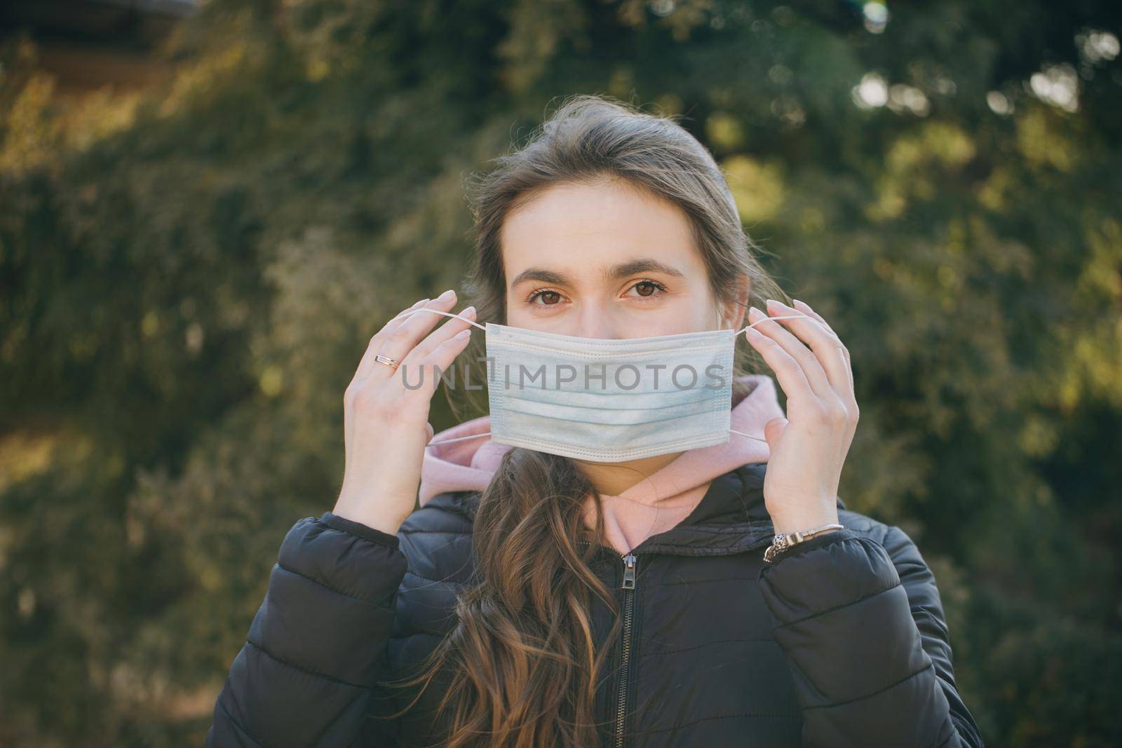 Beautiful Girl Wearing Medical Mask During Coronavirus COVID-19 Epidemic. Concept of health and safety life, N1H1 coronavirus, virus protection.