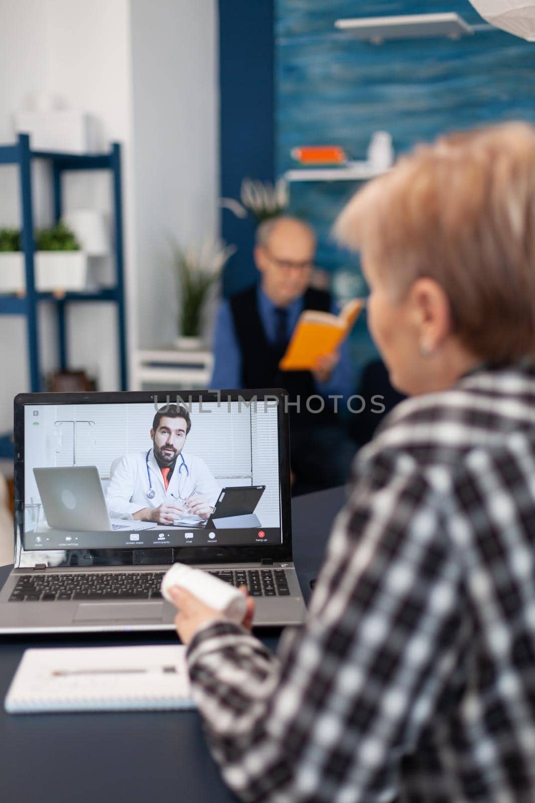 Sick senior woman talking with young doctor by DCStudio