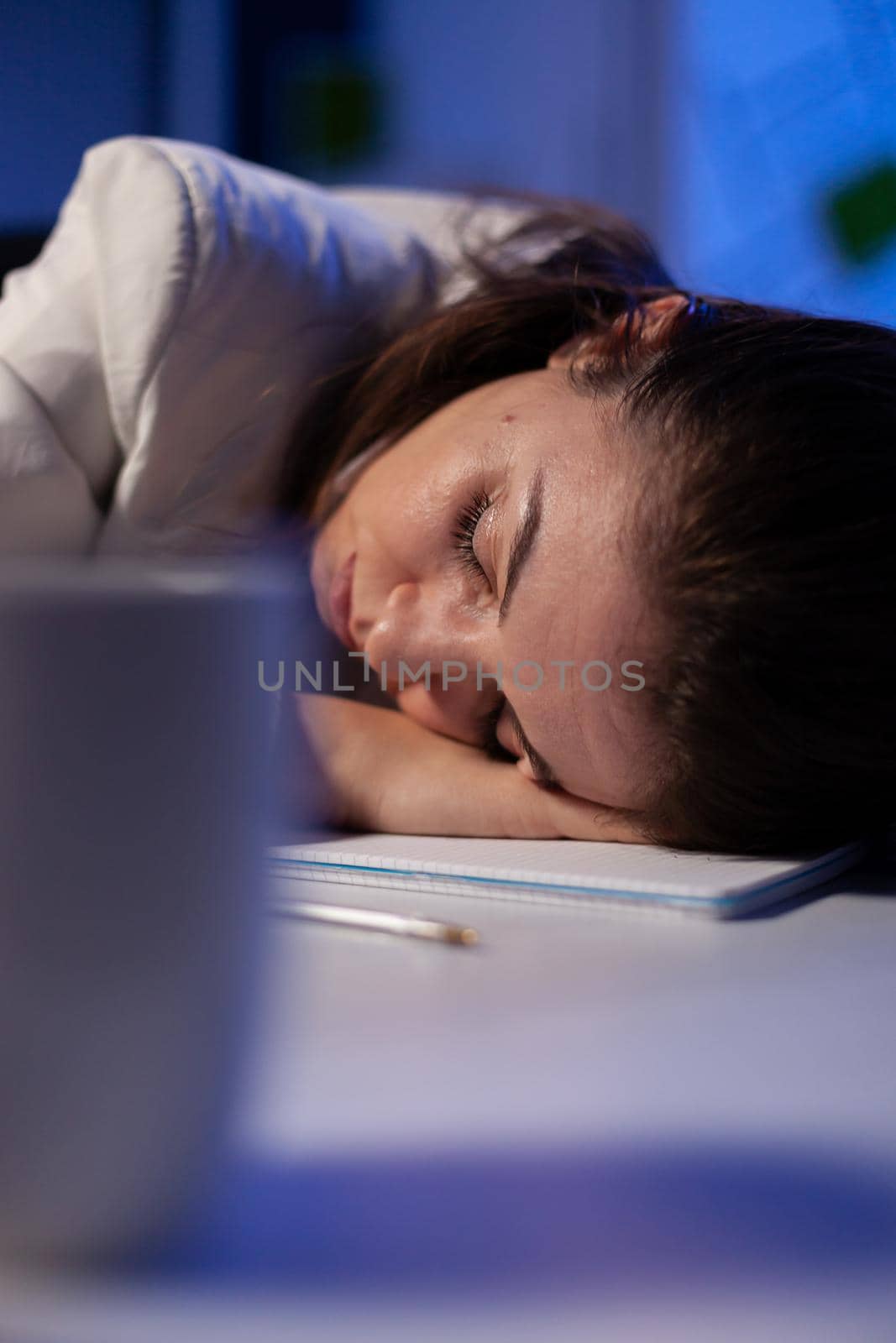 Business woman falling asleep while working at economic statistics late at night in office company. Executive boss working on financial project using modern technology network wireless