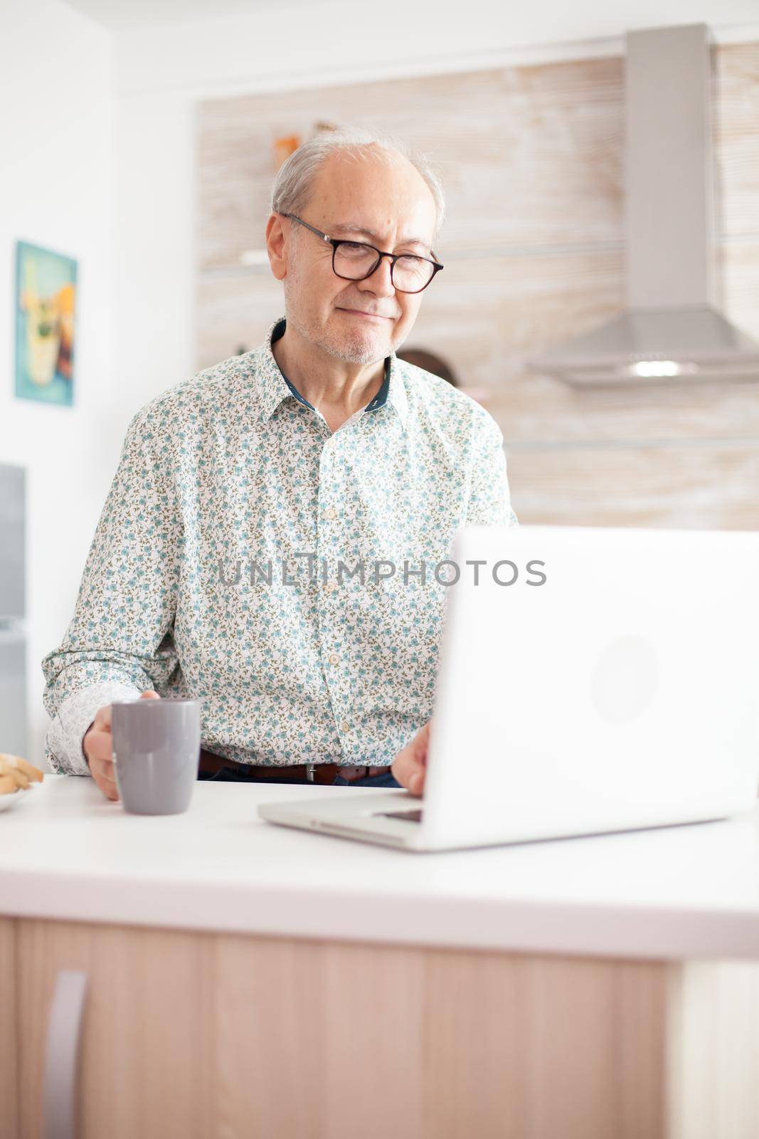 Old man smiling while watching a movie by DCStudio